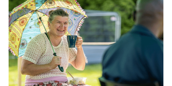 Lady with an umbrella in the sun at The Big Lunch