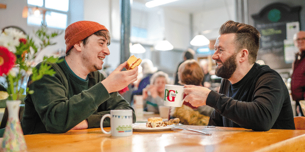 Two men chatting with tea
