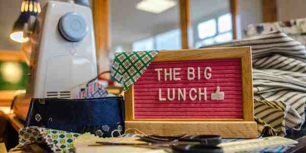 'The Big Lunch' sign amongst bunting fabric & sewing machine