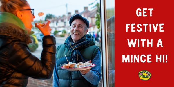 Man smiling and holding a plate of mince pies at a woman's front door with text: 'Get festive with a Mince Hi!'