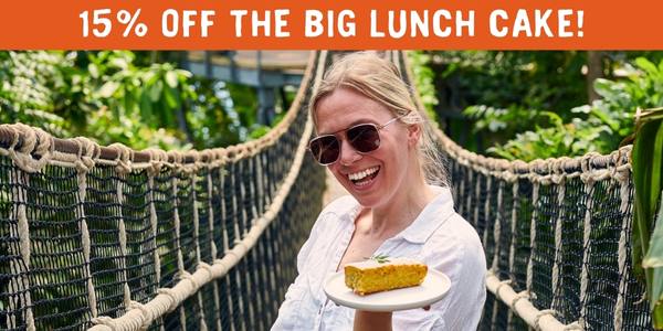 Women on a bridge in Eden Project biome with text: '15% off The Big Lunch cake!'