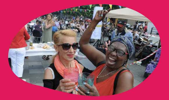 Two women cheering at a community even