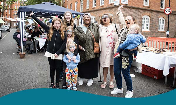 Community members cheering at a Big Lunch 