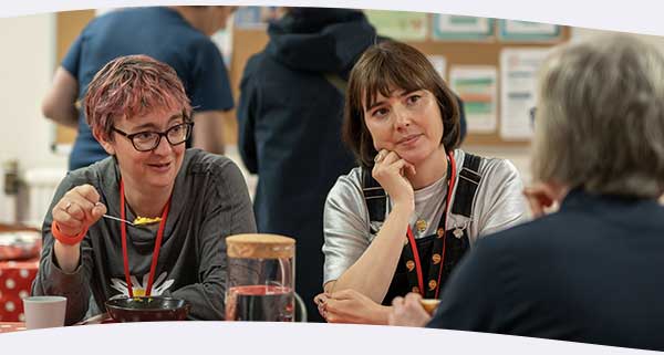 Three women chatting at a table