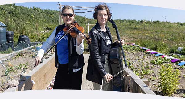 Two woman outside with violin and cello