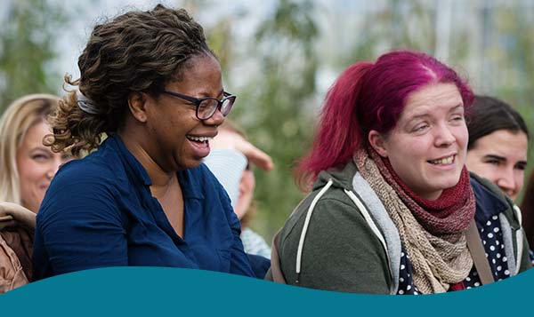 Community members smiling whilst at an Eden Project event