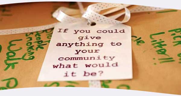 Community brainstorm with sign saying: 'If you could give anything to your community what would it be?'